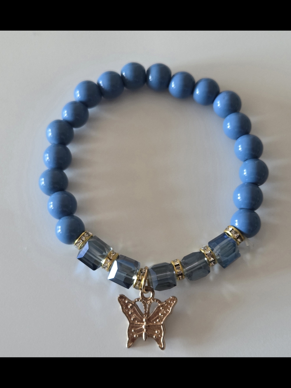 7 Inch Blue Beaded Bracelet with Gold Butterfly Charm